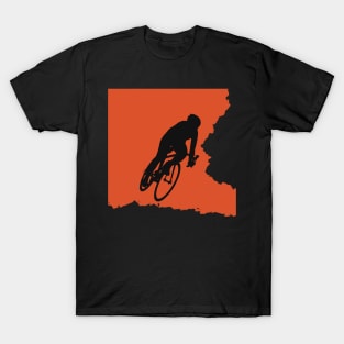 Bikerider rides the bicycle, black silhuette on orange background T-Shirt